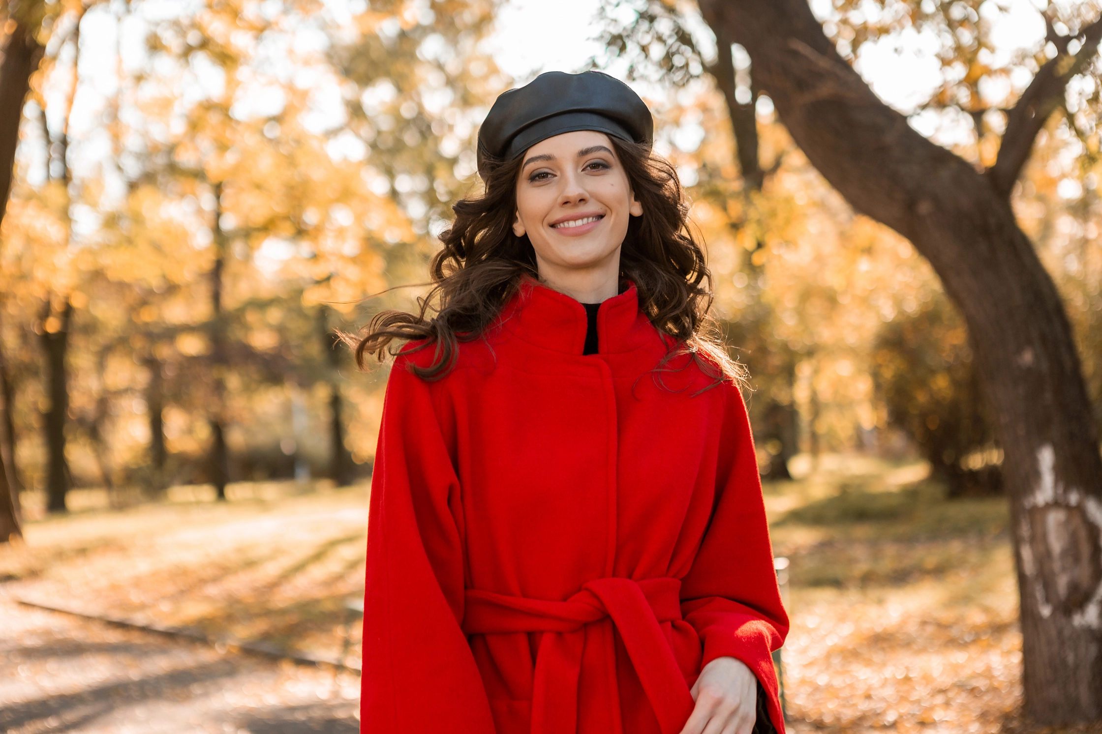attractive-stylish-smiling-woman-with-curly-hair-walking-park-dressed-warm-red-coat-autumn-trendy-fashion-street-style-wearing-beret-hat