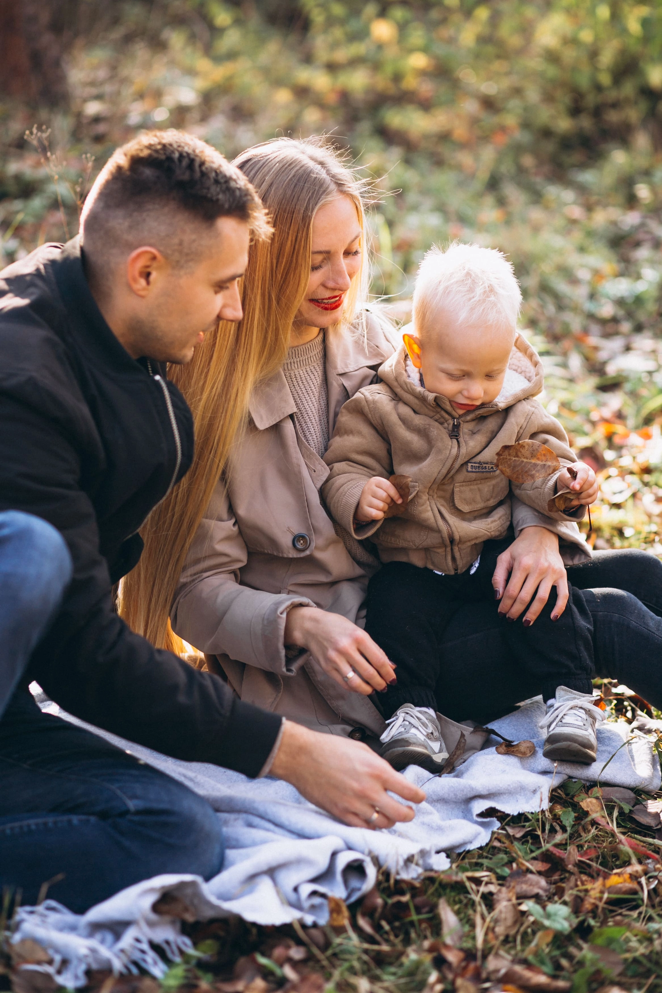 family-having-small-picnic-with-their-son-autumn-park