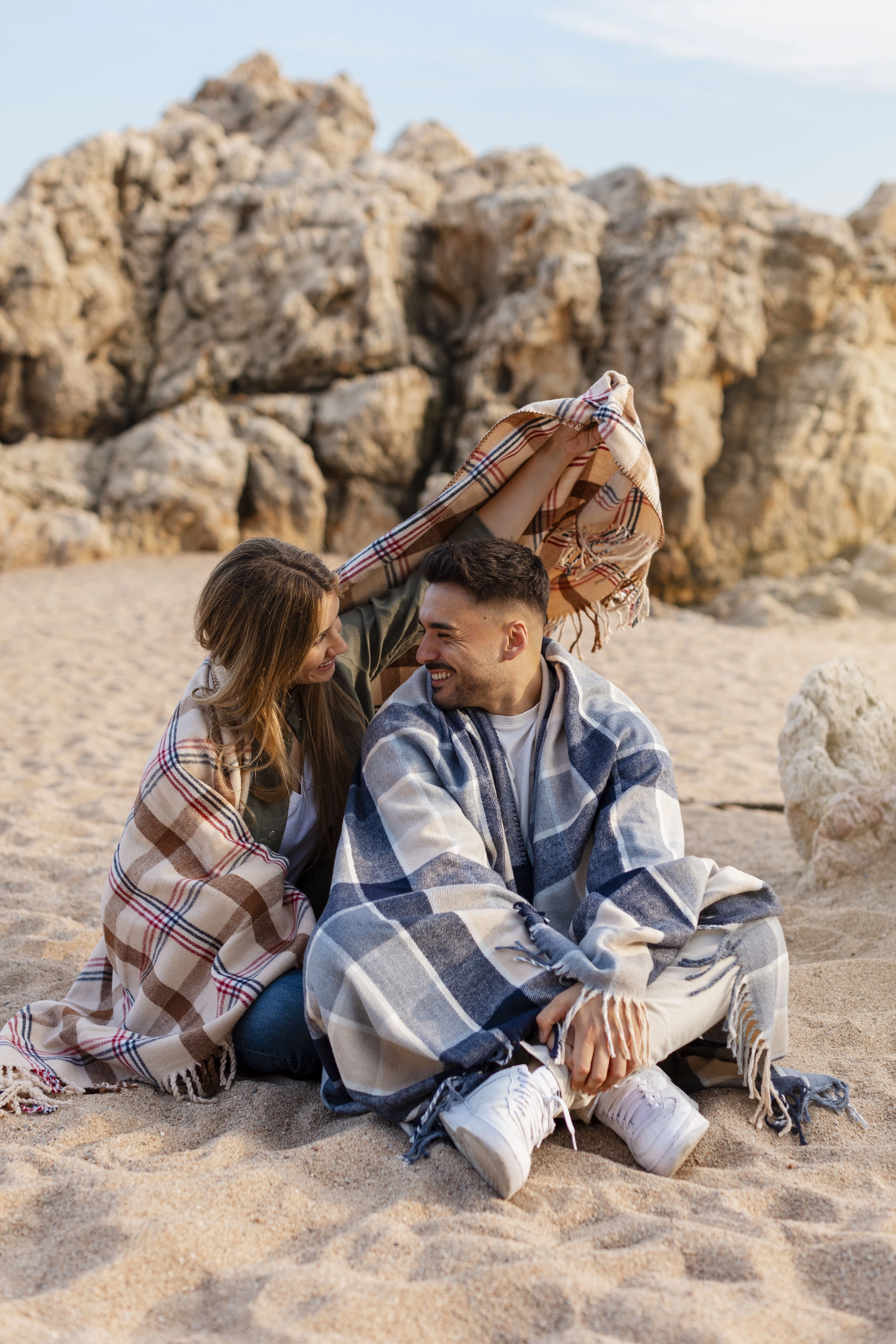 full-shot-romantic-couple-with-plaid-blanket
