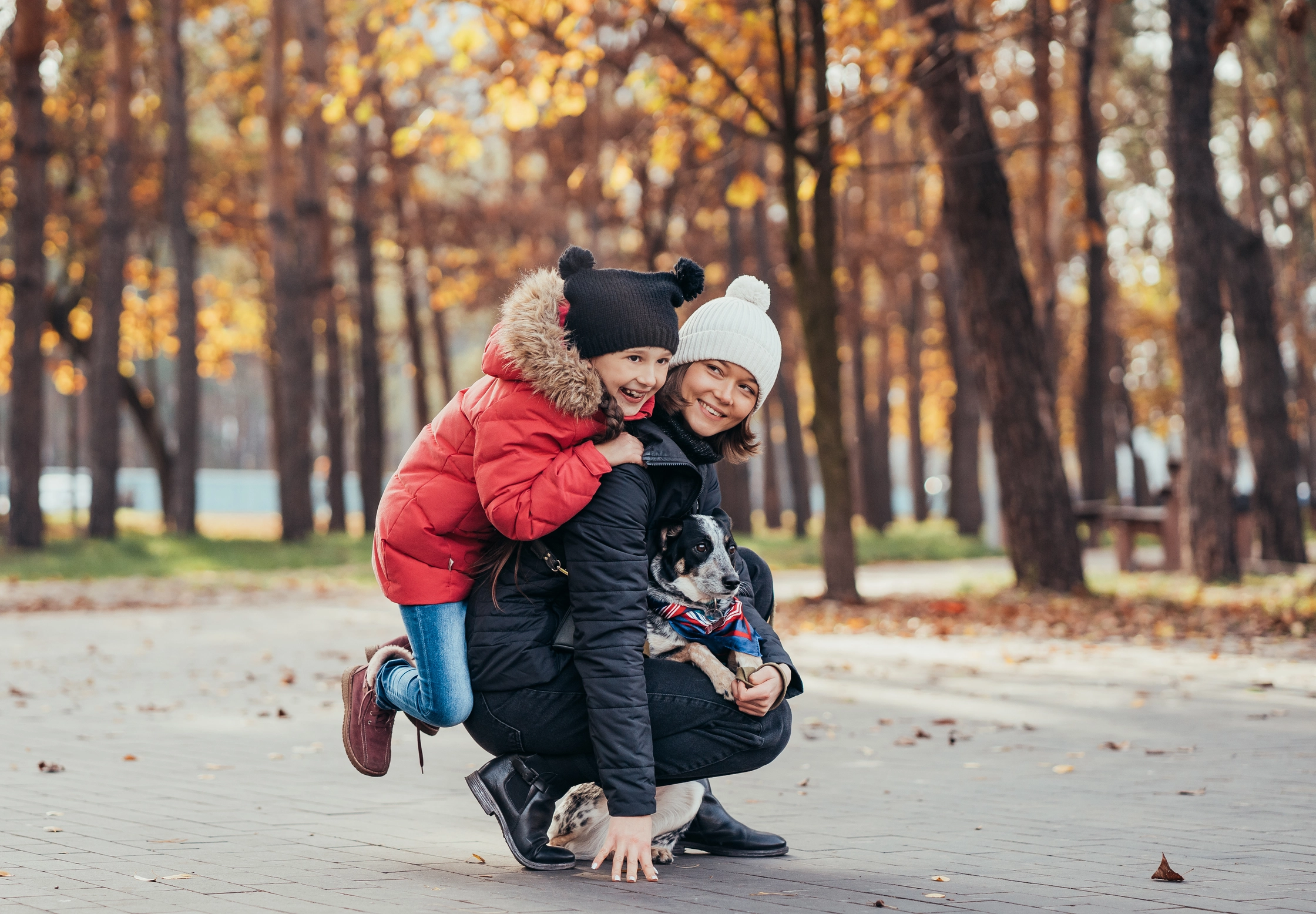 happy-mother-her-daughter-playing-with-dog-autumn-park