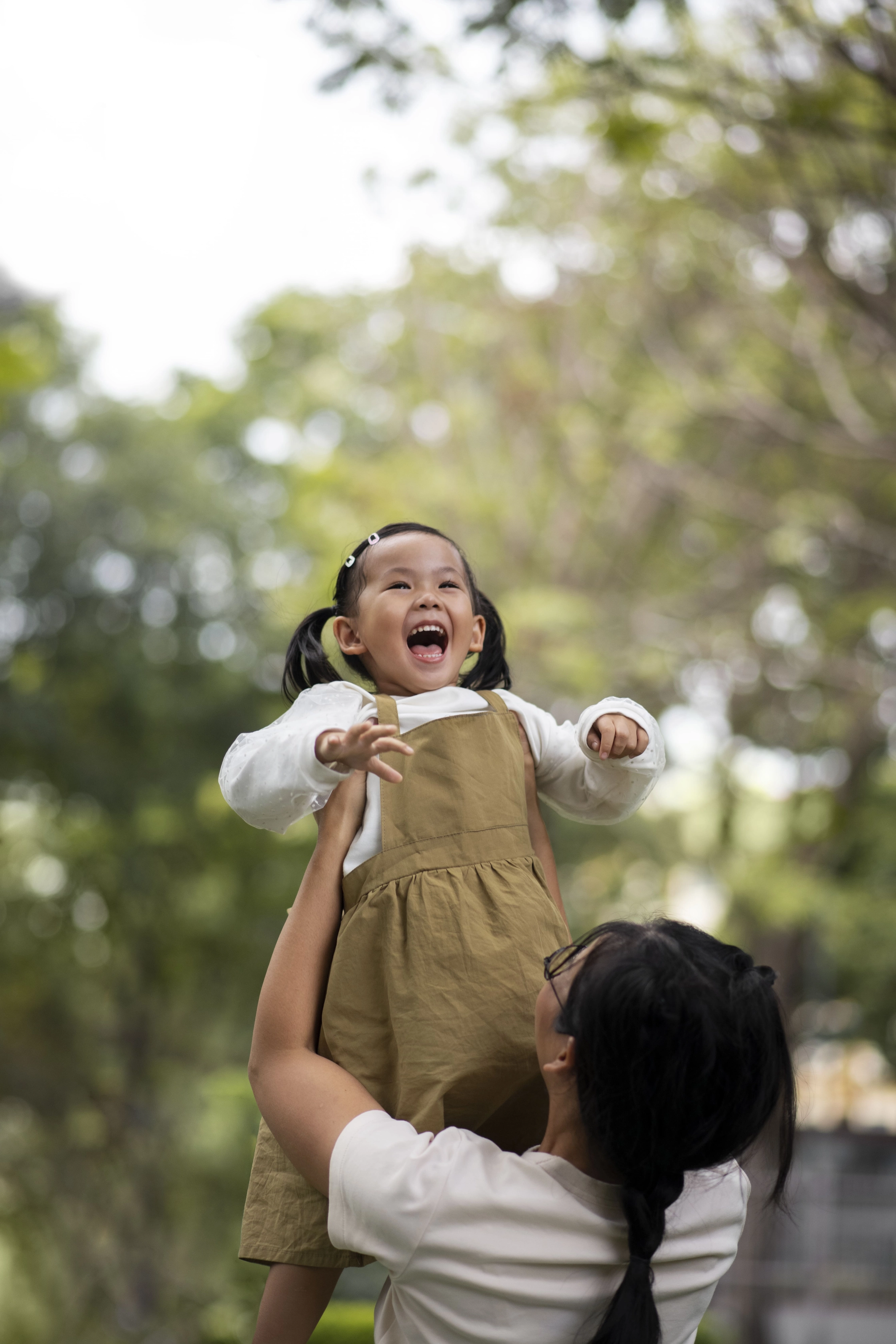medium-shot-mother-holding-girl-outdoors