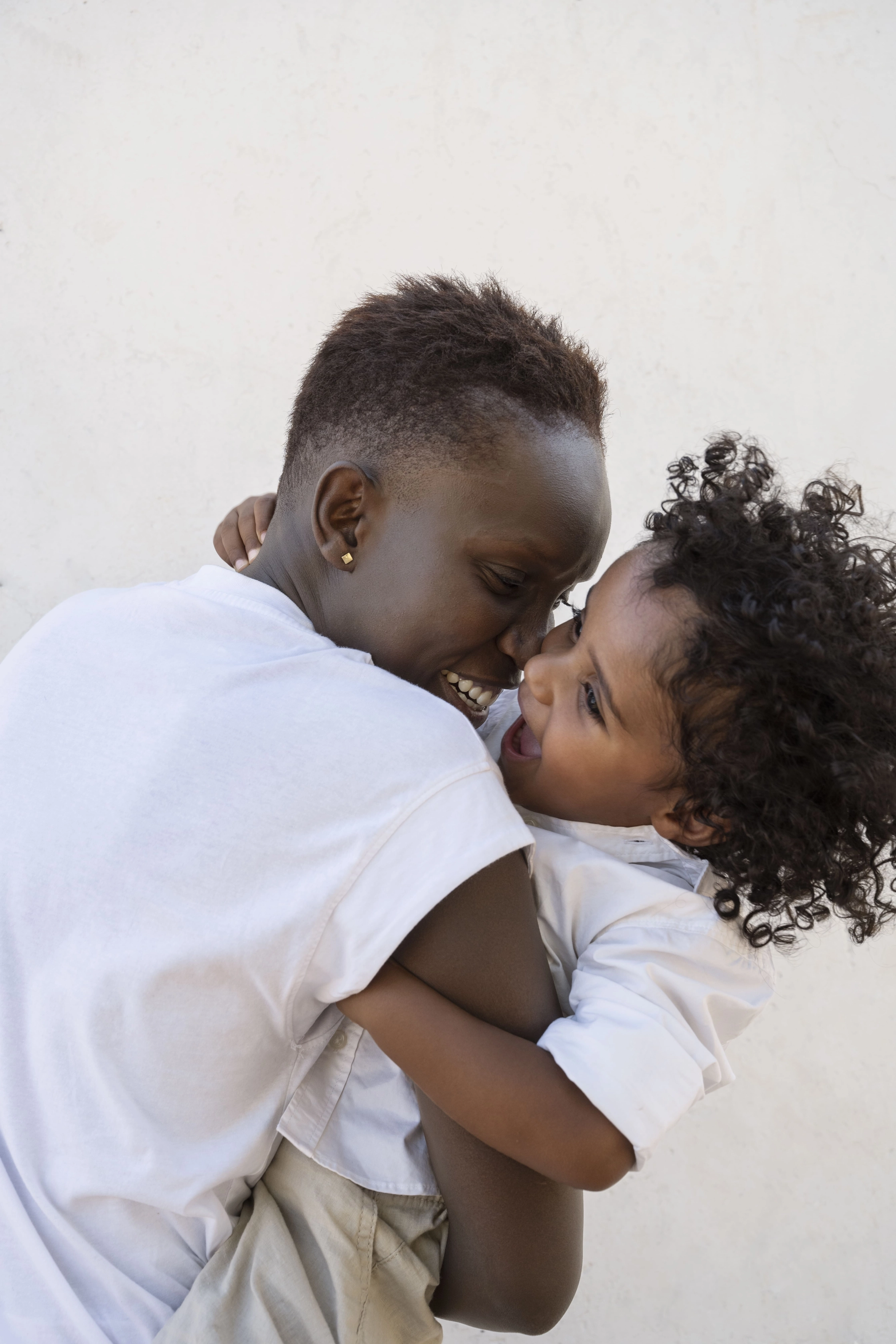 medium-shot-smiley-mother-hugging-kid