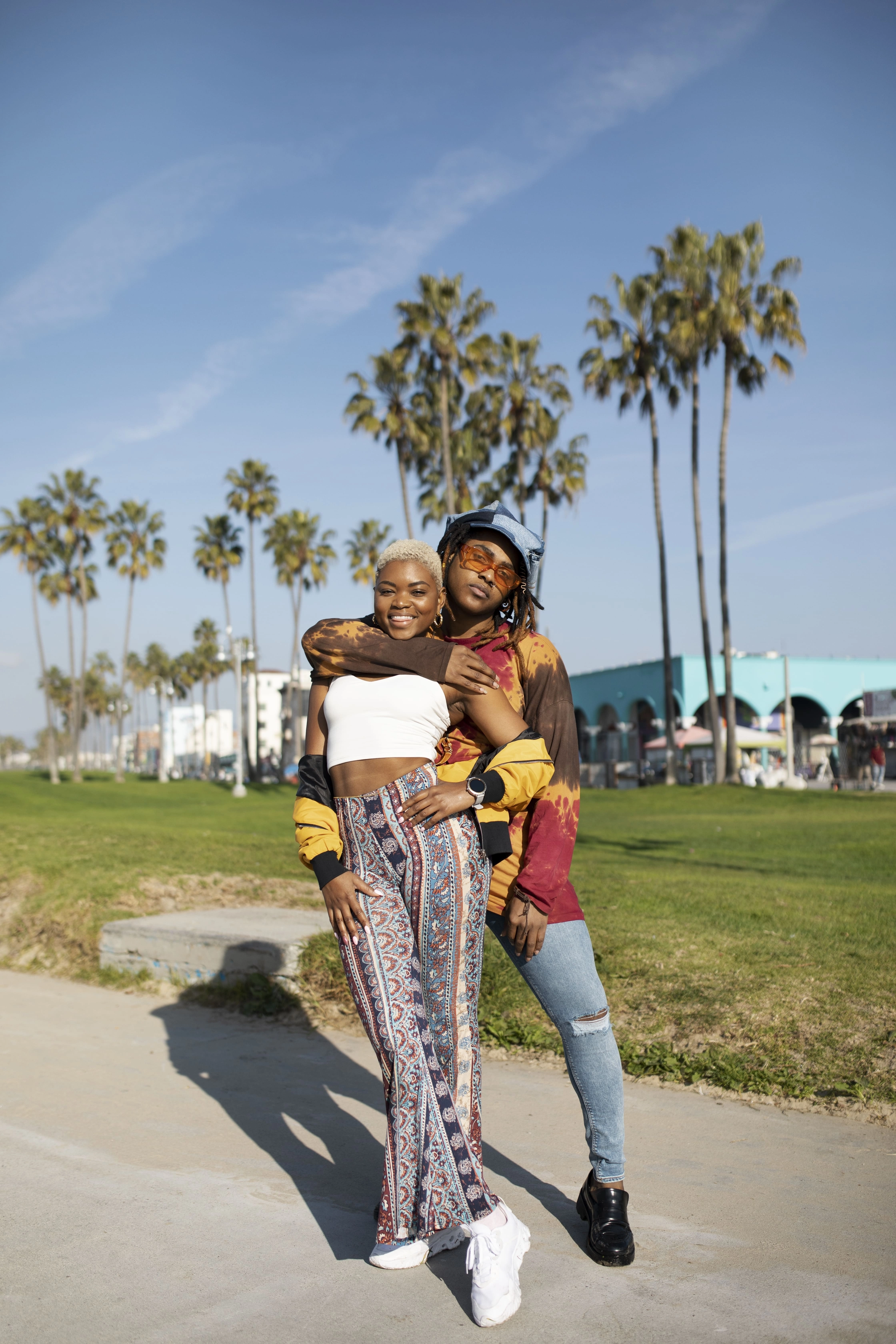 two-friends-posing-outside-park